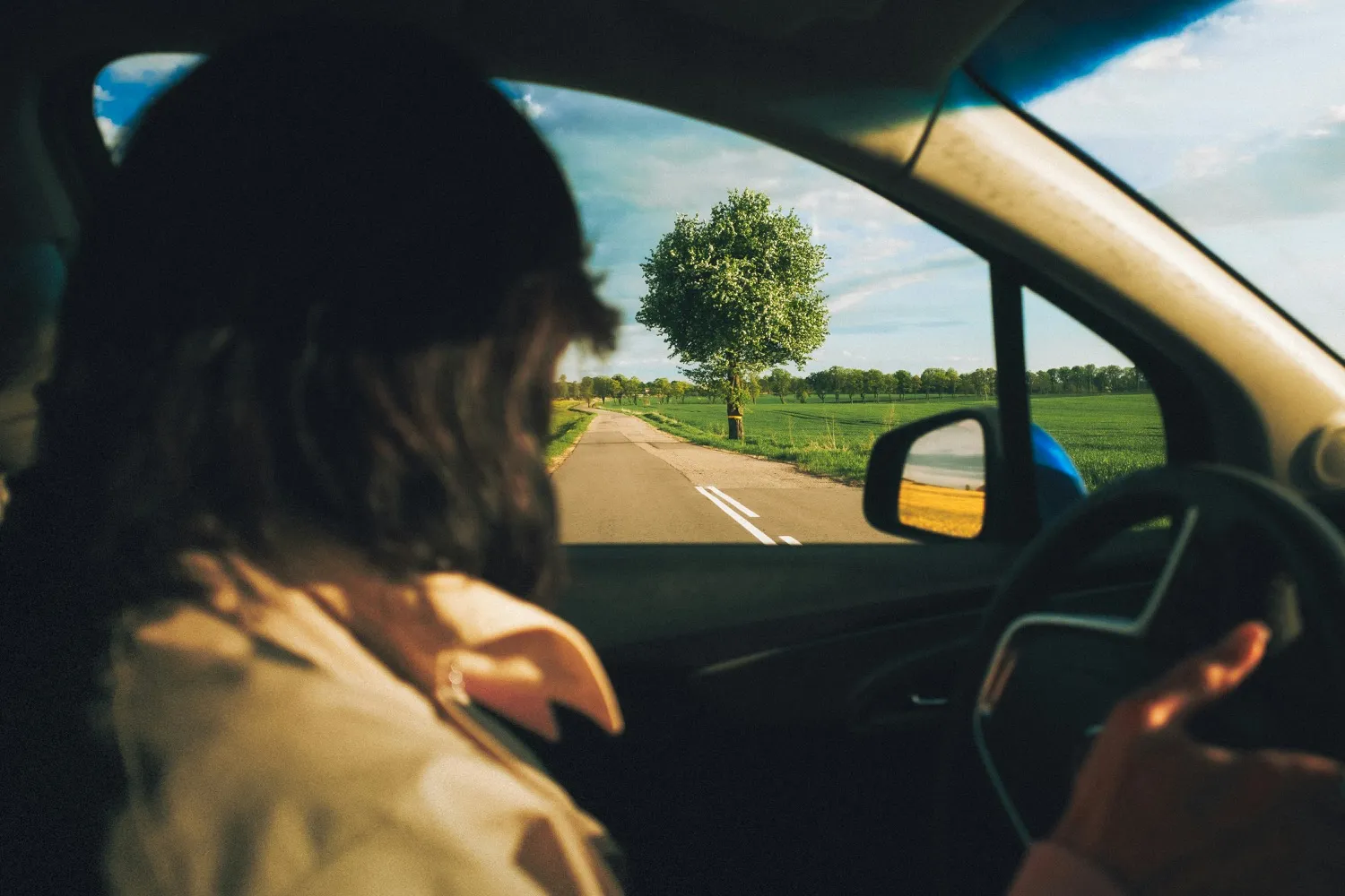 A driver looking ahead along a quiet country road